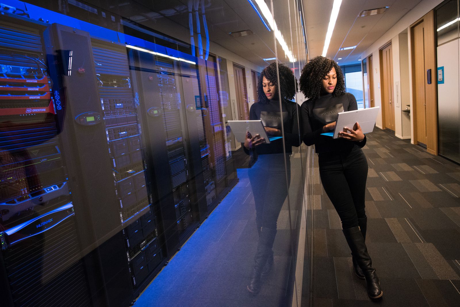 IT staff member working among server racks